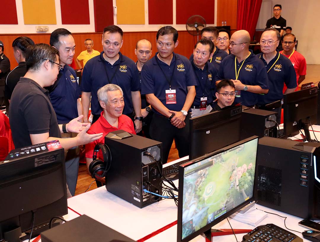 Prime Minister Lee Hsien Loong of Singapore learning to play Dota 2 at a community gaming event.